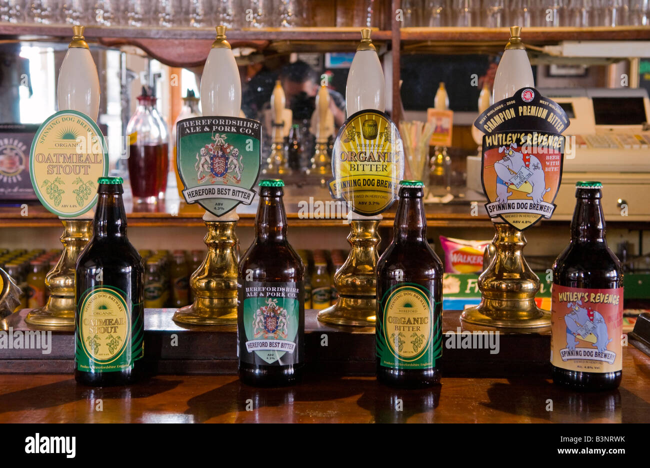 Selection of beer bottles next to pumps on bar of The Victory pub in