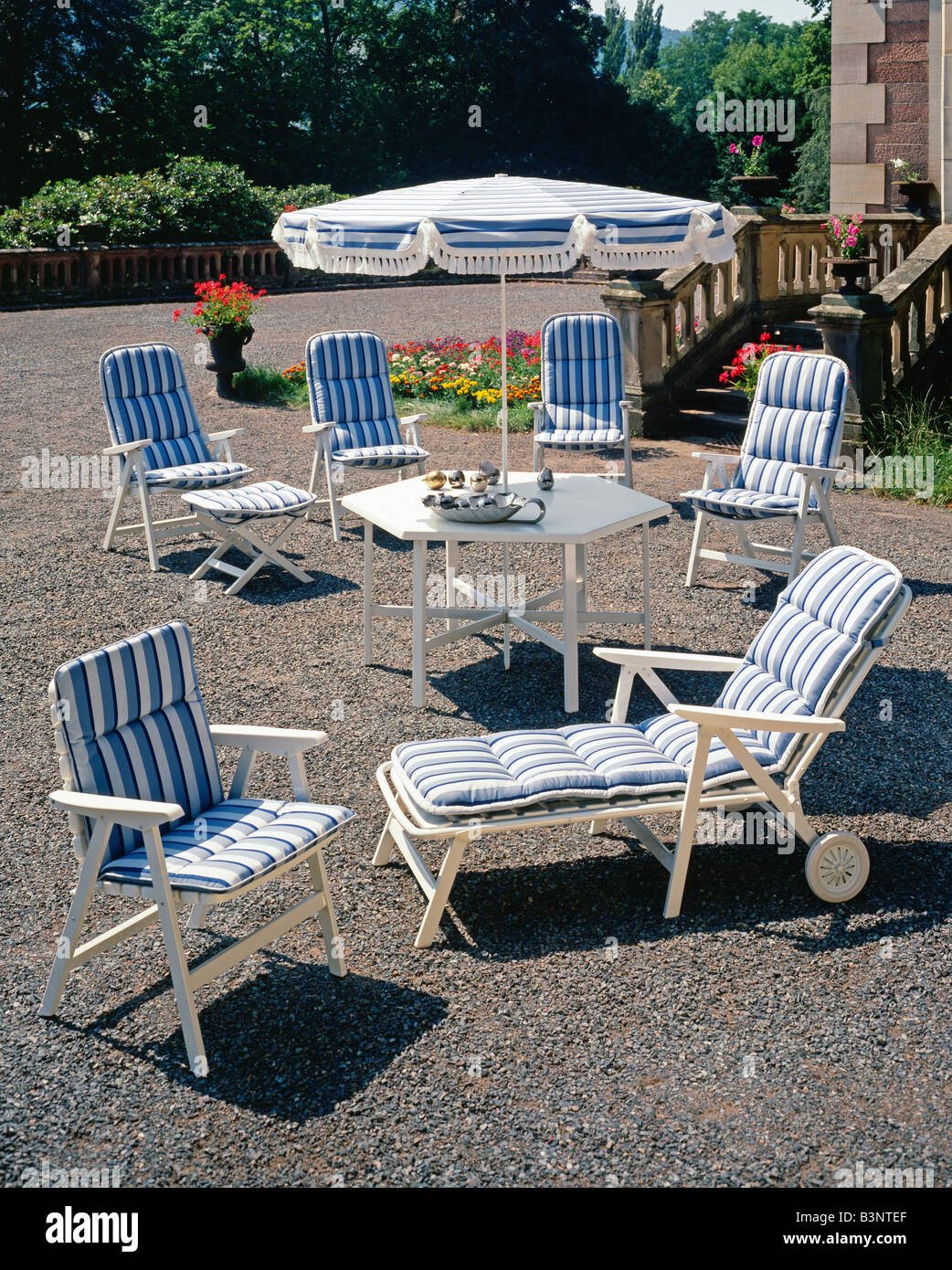 GARDEN FURNITURE CHAIRS ARMCHAIR AND PARASOL DECORATED WITH BLUE STRIPED  FABRIC, TERRACE, GRAVEL, ALSACE, FRANCE, EUROPE Stock Photo - Alamy