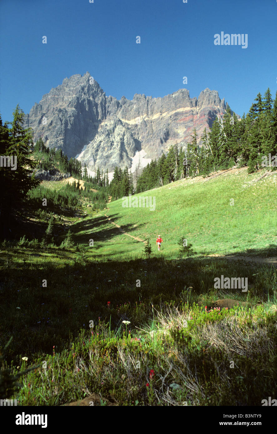 Hiker at base of Three Fingered Jack Mountain Oregon Stock Photo