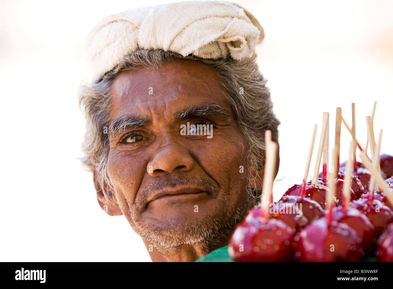 A man in Nicaragua selling candy covered apples ot toffee apples He has
