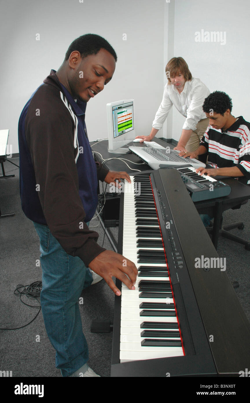 Group playing composing arranging and recording music in a studio Stock Photo