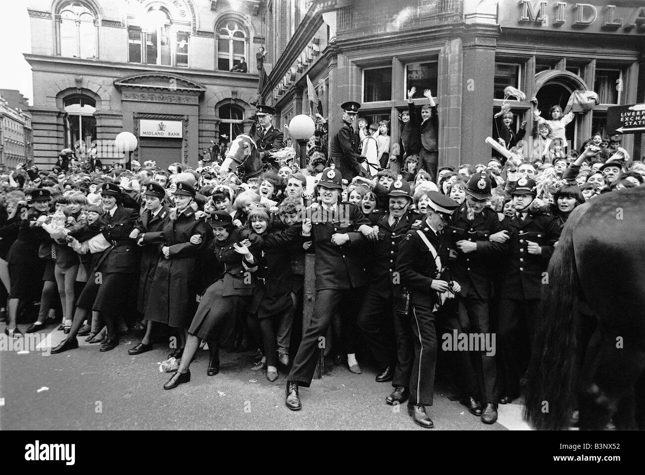 The Beatles July 1964 Crowds of fans outside the ABC theatre as the Beatles arrive controlled by police Stock Photo
