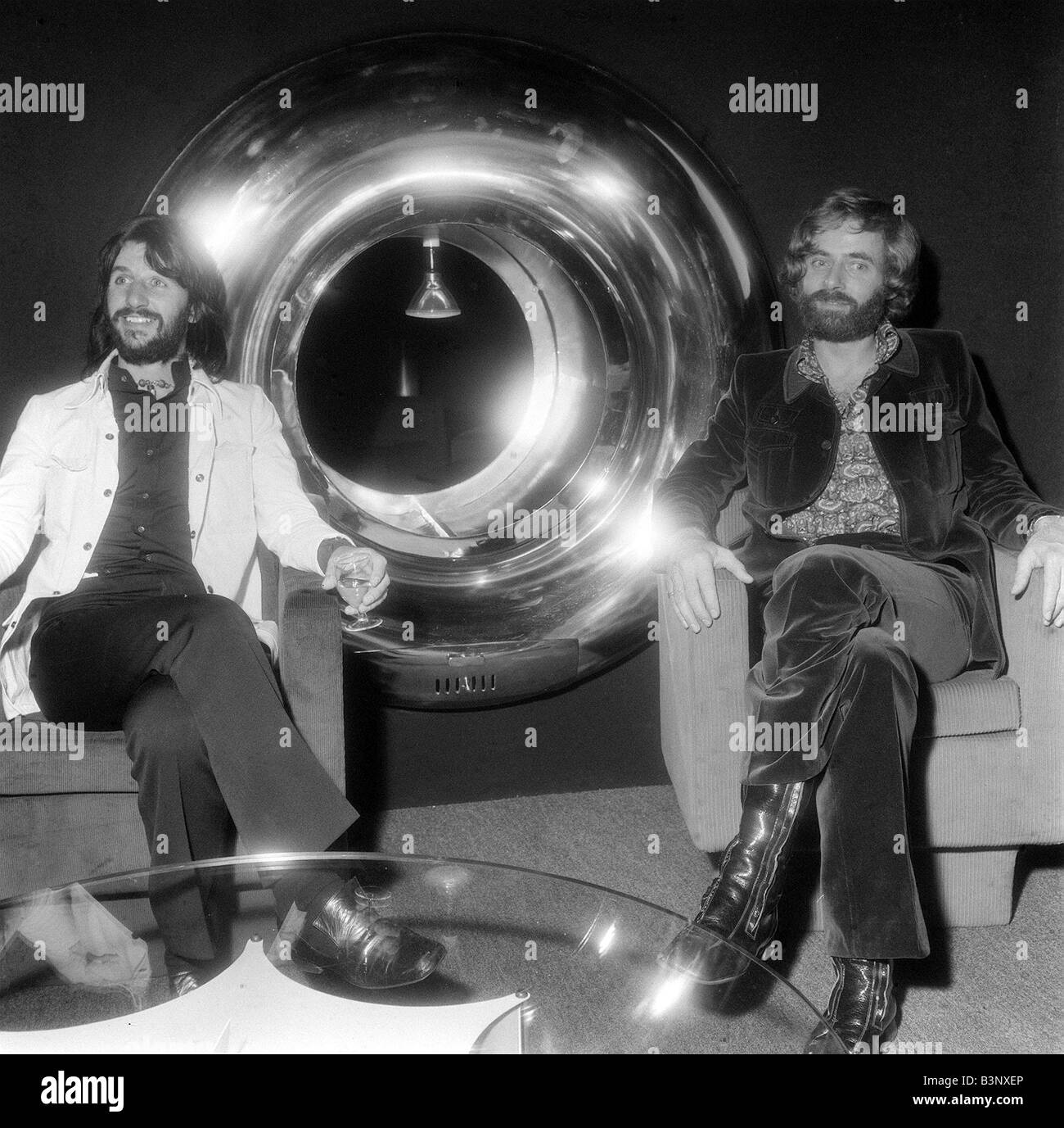 Former Beatles drummer Ringo Starr with designer Robin Cruickshank who is he is in partnership with The pair sit next to a fireplace they have designed priced 480 September 1971 Stock Photo