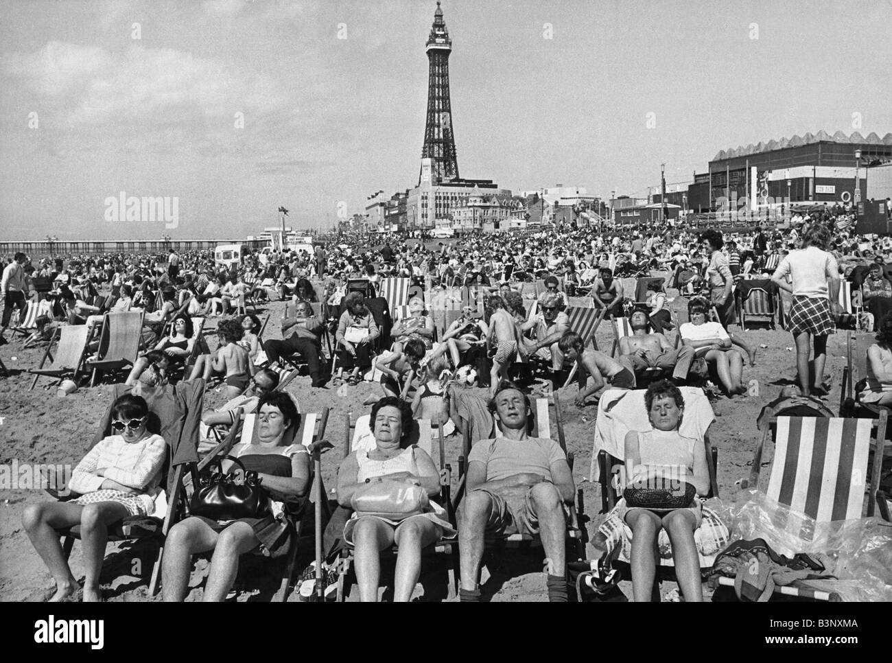 Holidaymakers sunbathing on Blackpool beach Blackpool Tower August 1972 Stock Photo