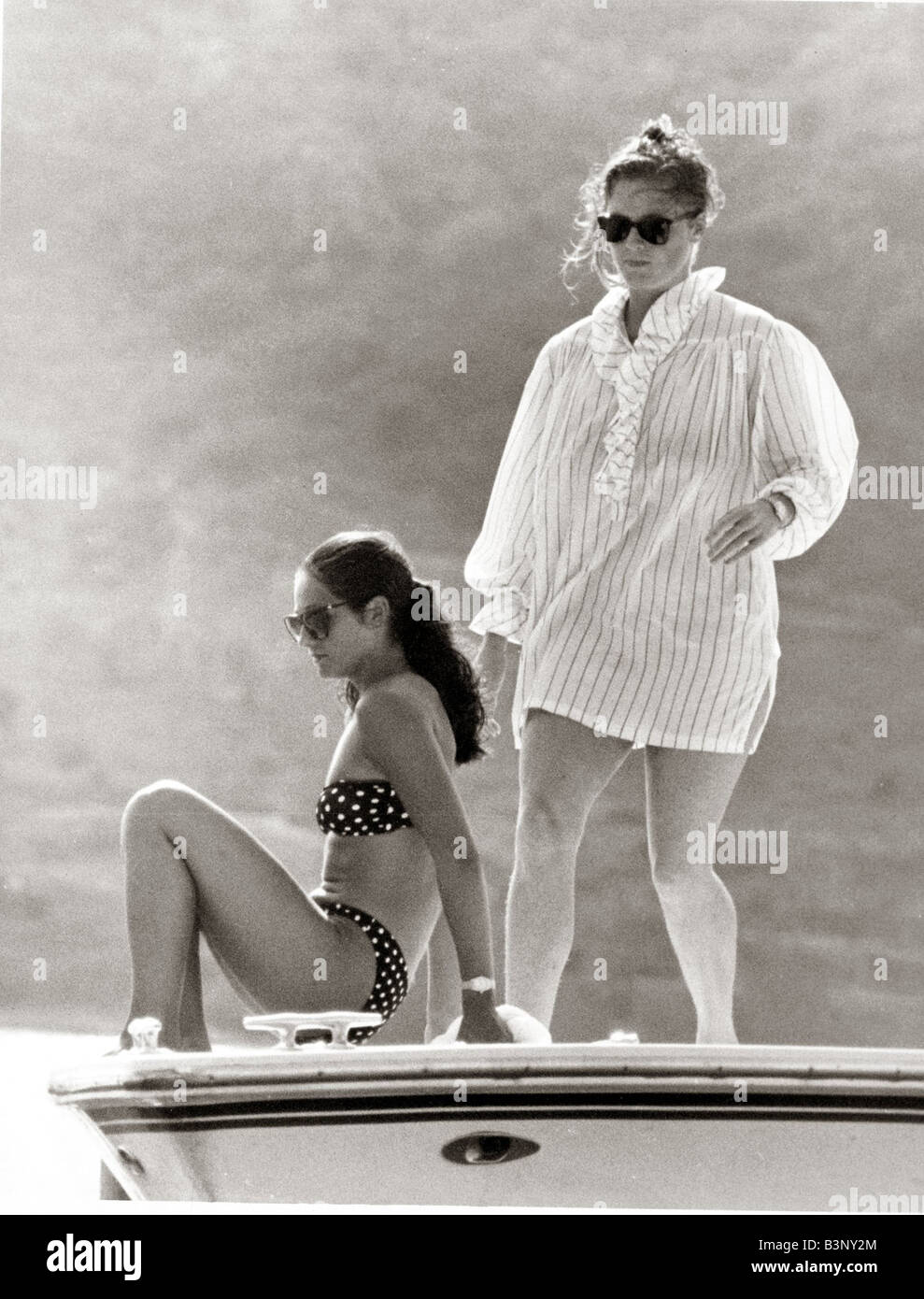 Sarah Ferguson covered up in sun wearing giant shirt Sunbathing with Princess Florence Belmondo in Antigua wearing polka dot bikini Looking silly June 1986 Stock Photo