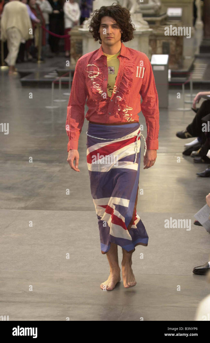 model at fashion show of men in skirts held at Vand A Museum designer Paul Smith polka dot shirt yellow T shirt and union jack sarong February 2002 Stock Photo