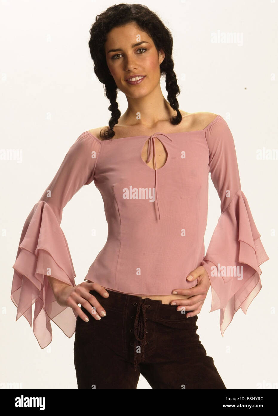 Fashion Feature June 2002 Romantic Tops Feature A model wearing a pink top  with flared sleeves and trousers Stock Photo - Alamy