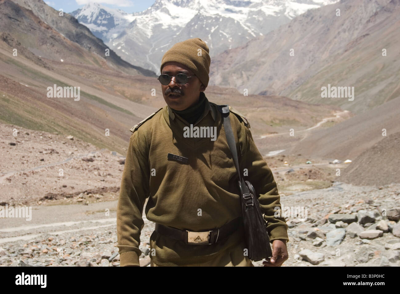 Military local man on road with mountain on background Stock Photo