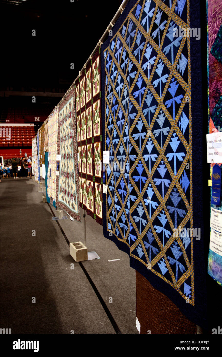 Row of hanging quilts at the quilt exhibit competition at the state fair. Stock Photo