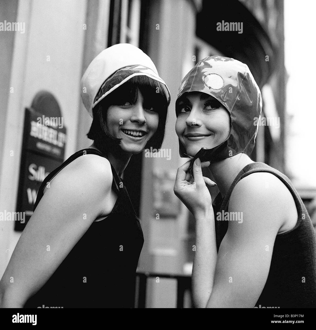 Two models model hats June 1965 One wears a white hat with dark
