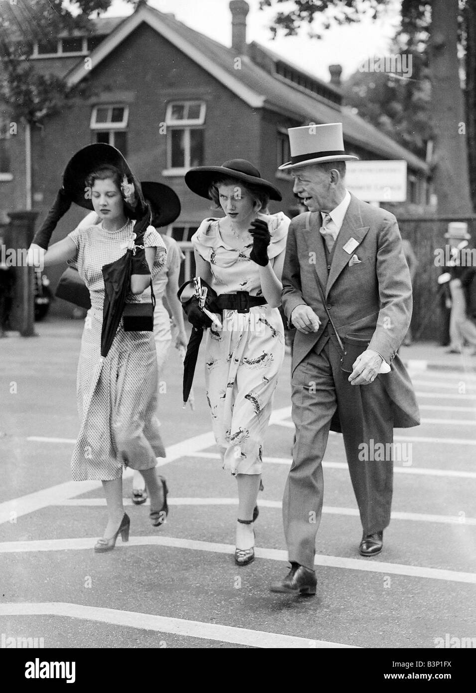 1950 Clothing Ascot Fashion Crossing the road holding onto their hats ...