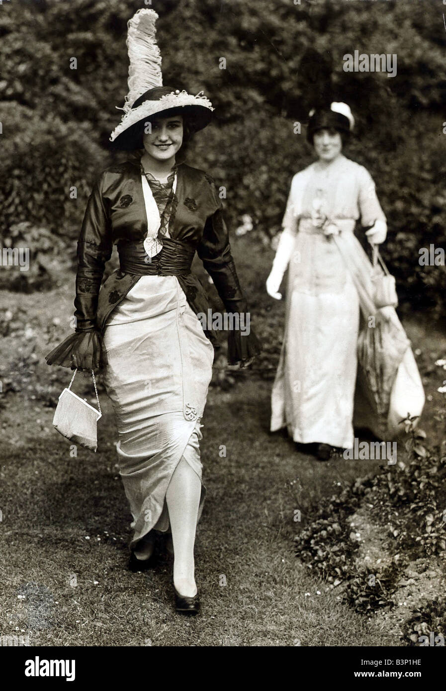 1913 Clothing Ascot Fashion Hats and Dresses Wearing a slit skirt dress ...