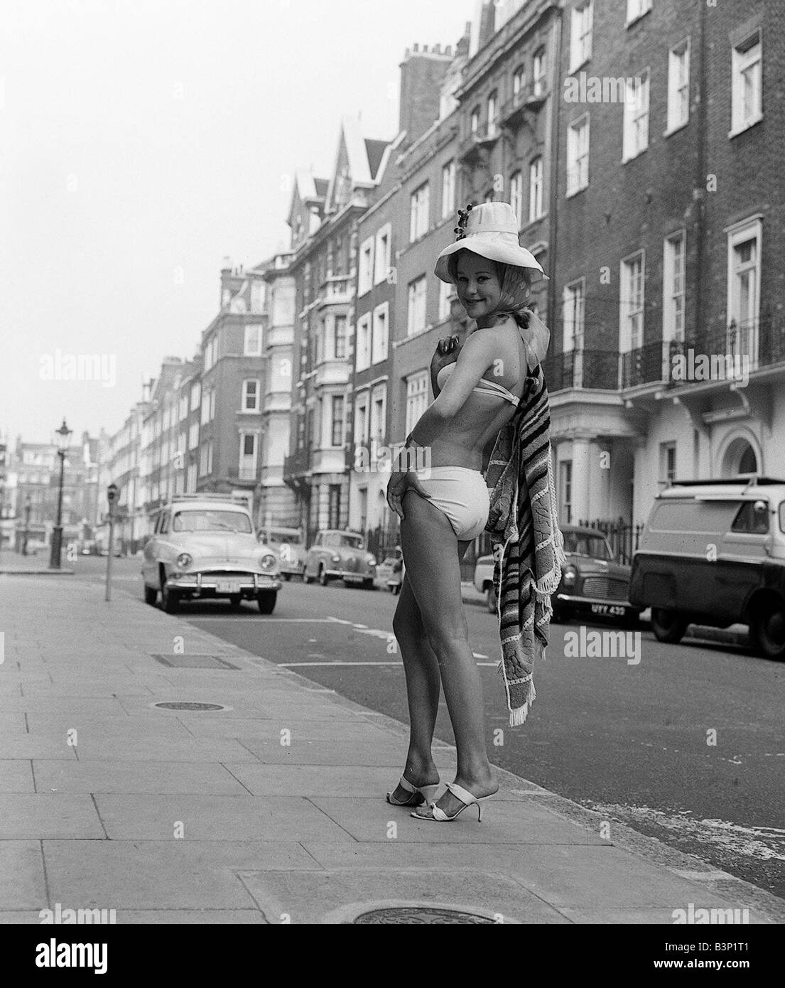 1960s Fashion Clothing October 1961 Judy Edwards 16 rehearses for the end of term fashion show at The Charm Show for would be models in Welbeck Street London Pictured wearing two piece bikini and floppy hat Stock Photo