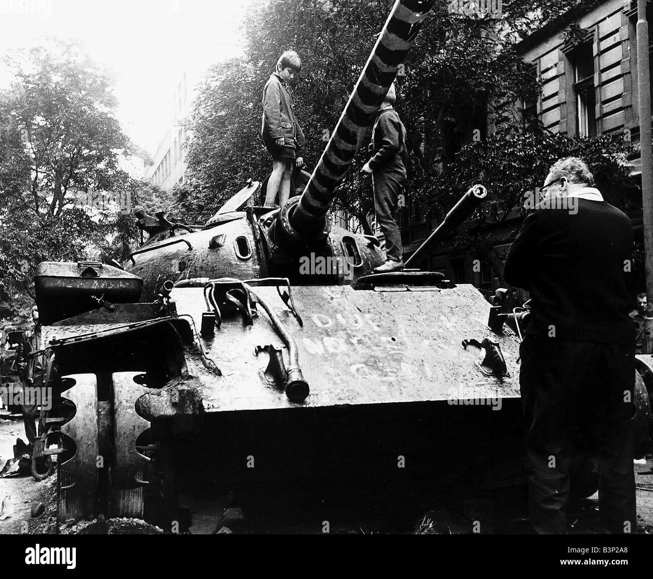Children play on Russian tank in Prague during Russian Invasion in 1968 Stock Photo