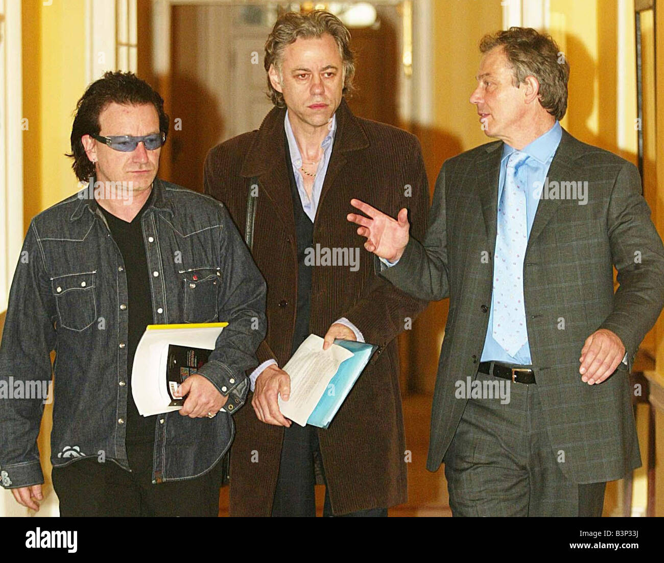 Britain s Prime Minister Tony Blair May 2003 right escorts Sir Bob Geldof center and U2 frontman Bono inside 10 Downing Street London Thursday May 22 2003 Blair met with the rock stars who were urging world leaders to unite in the fight against the AIDS epidemic Stock Photo