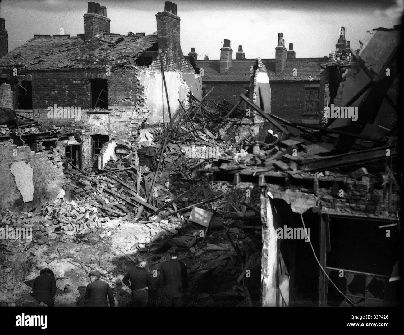 WW2 Merseyside Air Raid Bomb Damage 1940 Civilians and rescue workers search through the bomb damaged houses in Liverpool following a bombing raid by the Luftwaffe The German Airforce during the blitz Stock Photo
