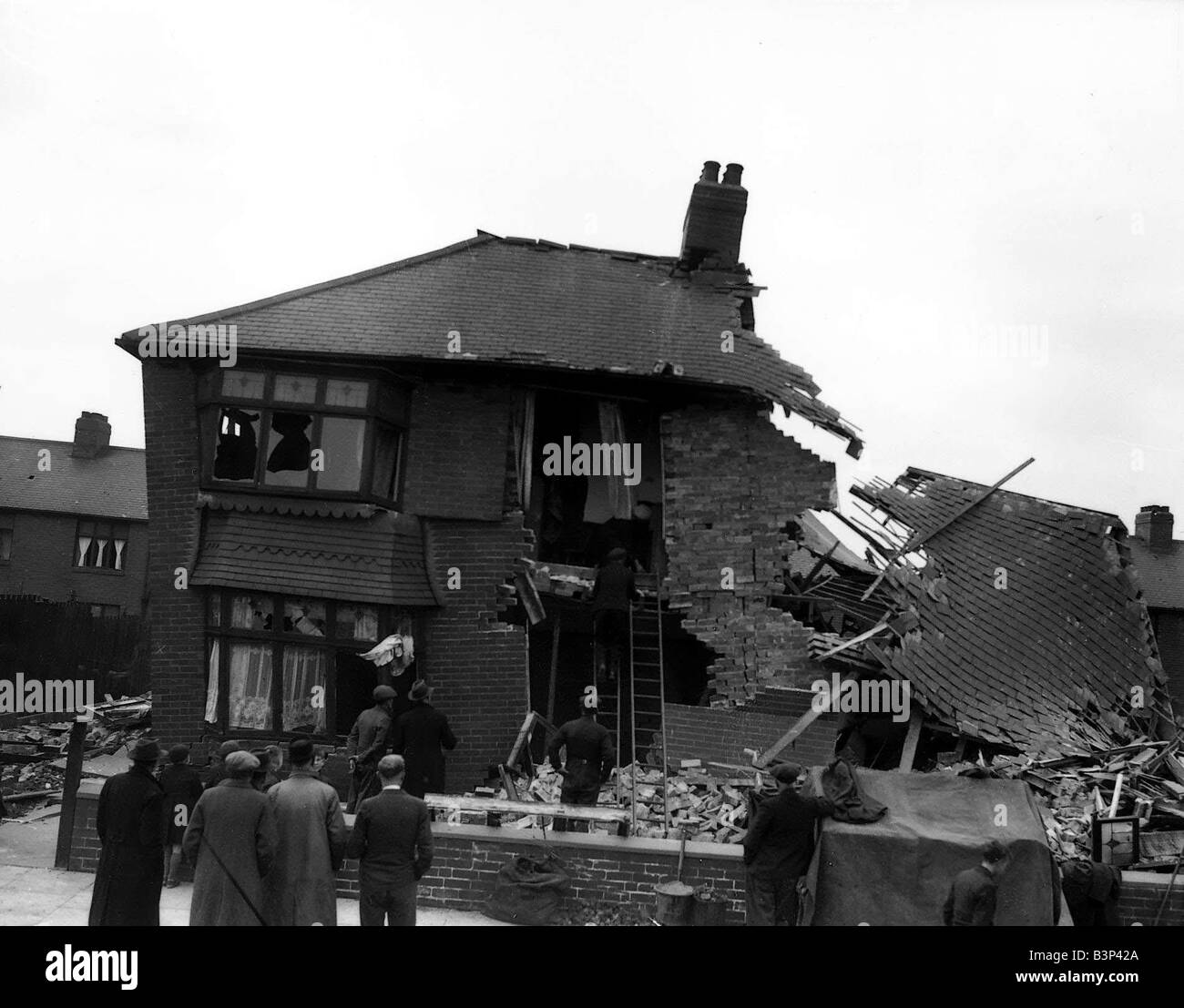 WW2 York Air Raid Bomb Damage Civilians and rescue workers search through a bomb damaged house in the suburbs of York following Stock Photo