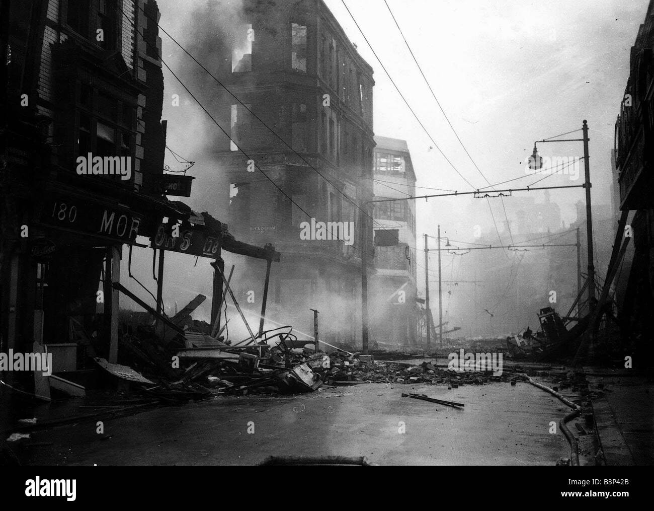 WW2 Air Raid Bomb Damage Portsmouth 1940 A firmens hose plays water on to the smouldering