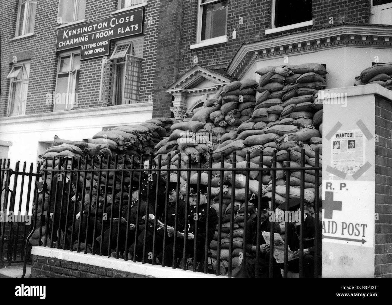 WW2 London The Blitz Firemen Firemen reading their newspapers outside their sandbagged fire station at Kensington Close West London during The Blitz Stock Photo