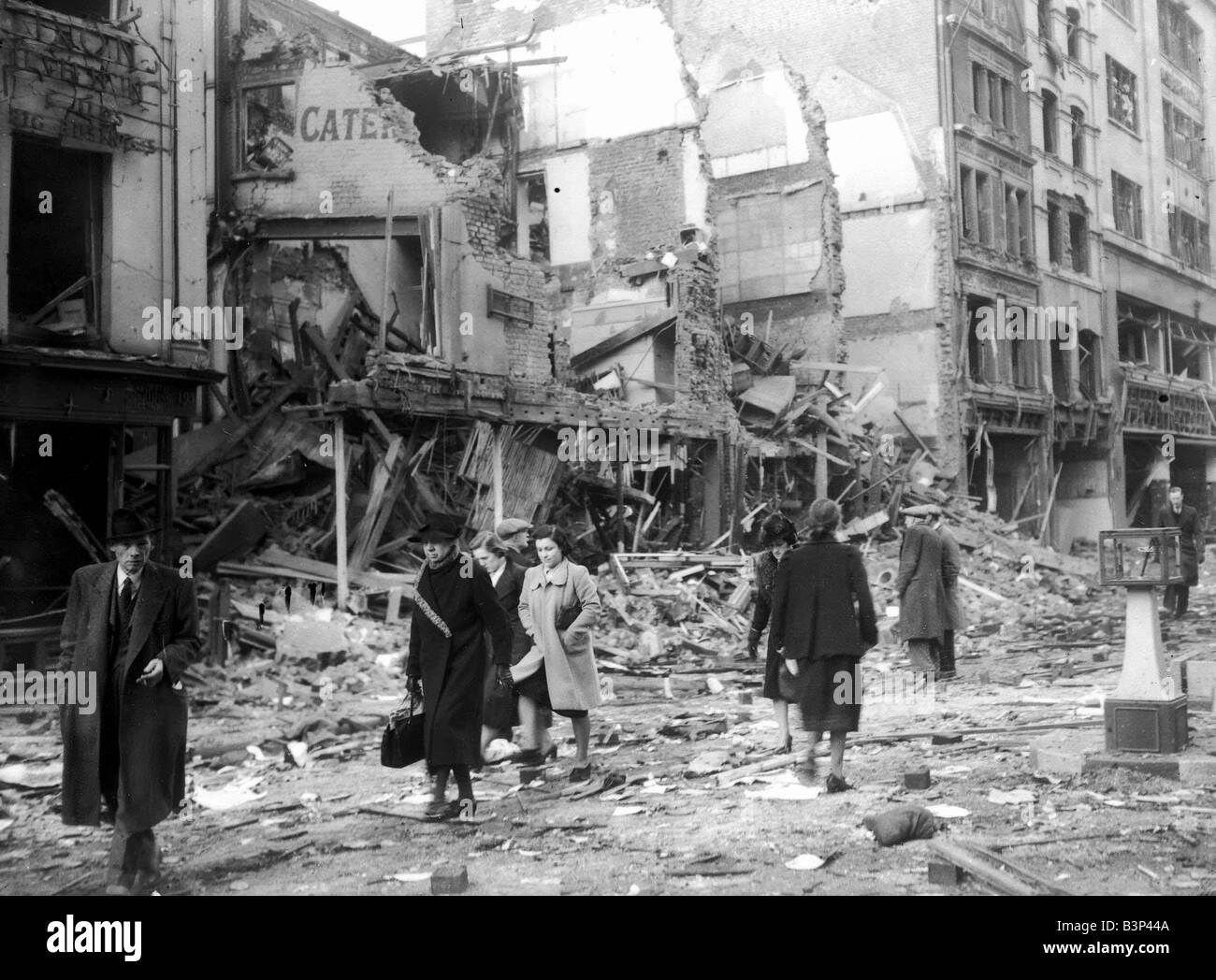 WW2 Air Raid Damage April 1941 Bomb damage in London People clear the streets walking around rubble and debris left by the air Stock Photo
