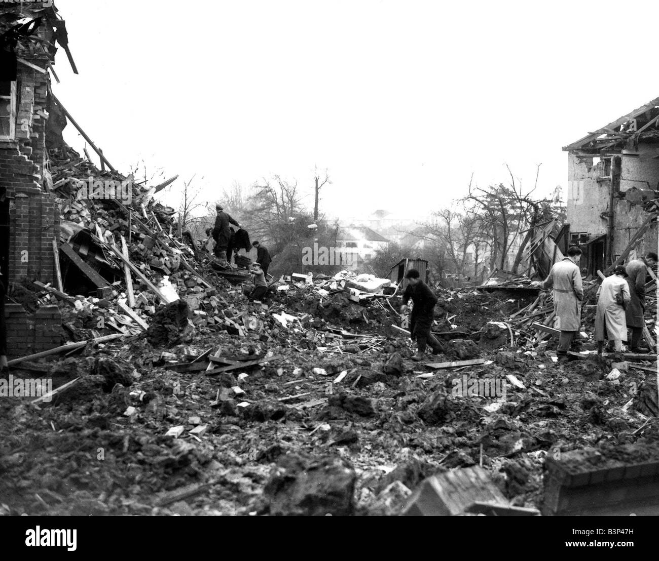 WW2 Air Raid Damage Bristol Civilians searching through rubble of their bomb damaged houses after an air raid on Bristol by the Stock Photo