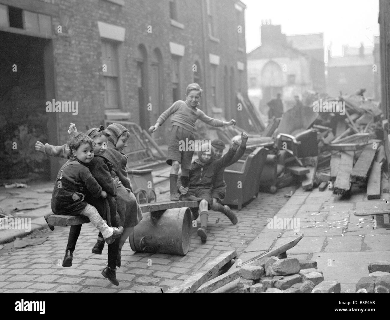 WW2 Children Playing Games Children make a see saw out of an upturned