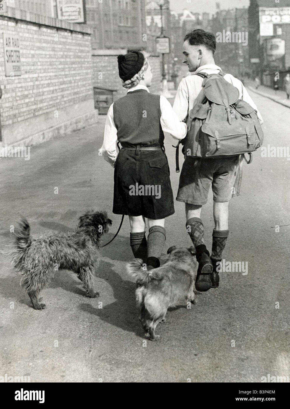A young couple hiking with their dogs down a Manchester Stock Photo - Alamy