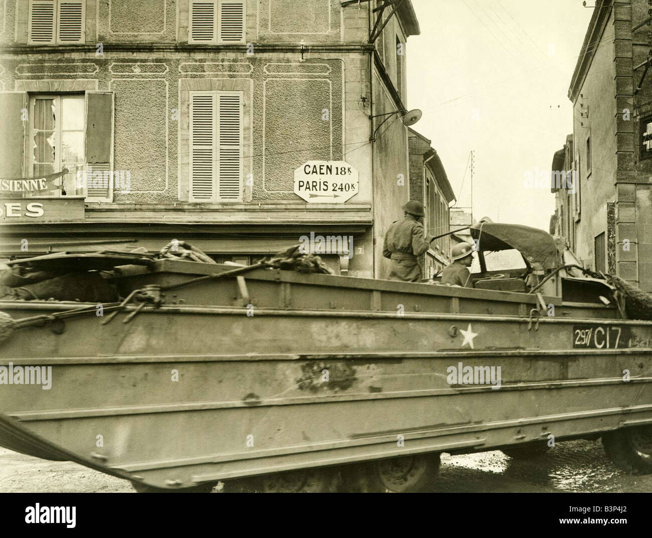 World War II Invasion of France D Day 8 A British army DUKW passes through the Normandy village of Courseulles during the push towards Caen June 1944 Stock Photo