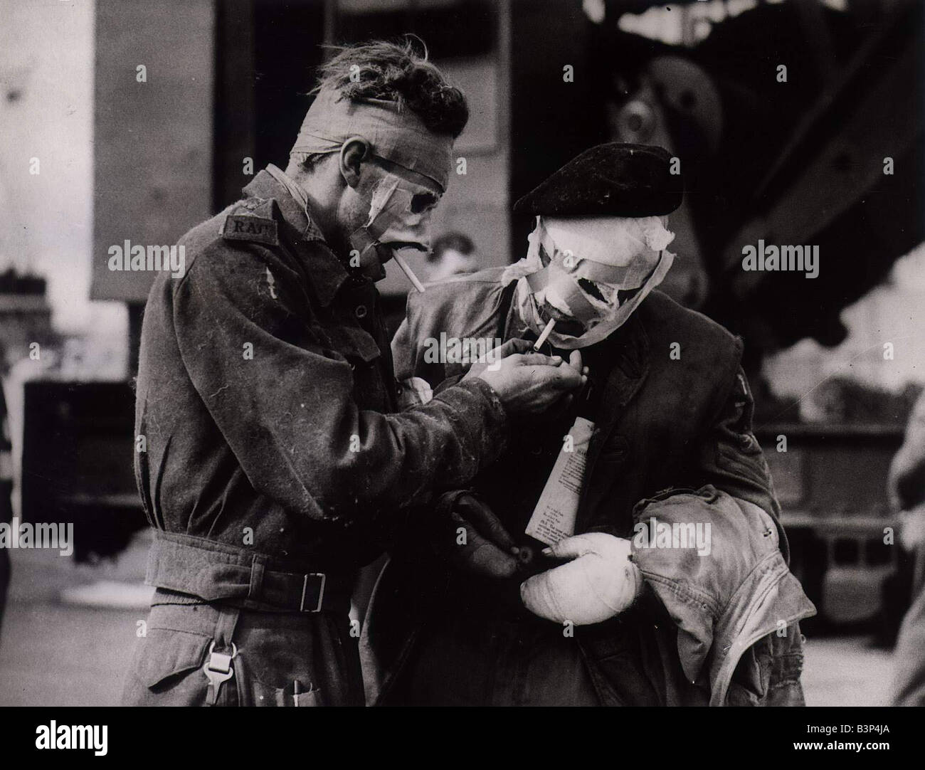 World War II Invasion of France Two soldiers casualties of the Normandy landings enjoy a cigarette after disembarking from the hospital ship Stock Photo