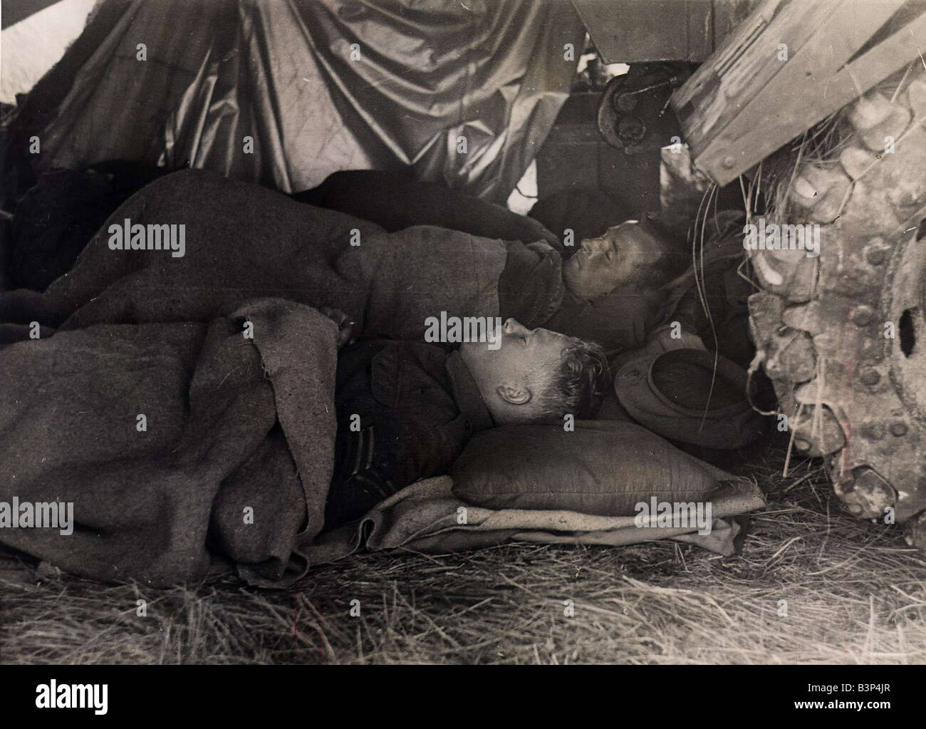 World War II Invasion of France Operation Overlord British tank crew having a rest sleeping under the protection of their tank Stock Photo