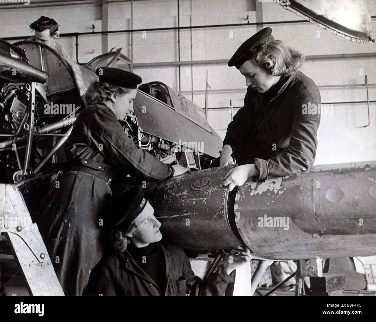 Air Maintenance Wrens at work on Fleet air fighter planes assembling an oil tank on plane Aircraft maintenance 1940s March 1943 Stock Photo
