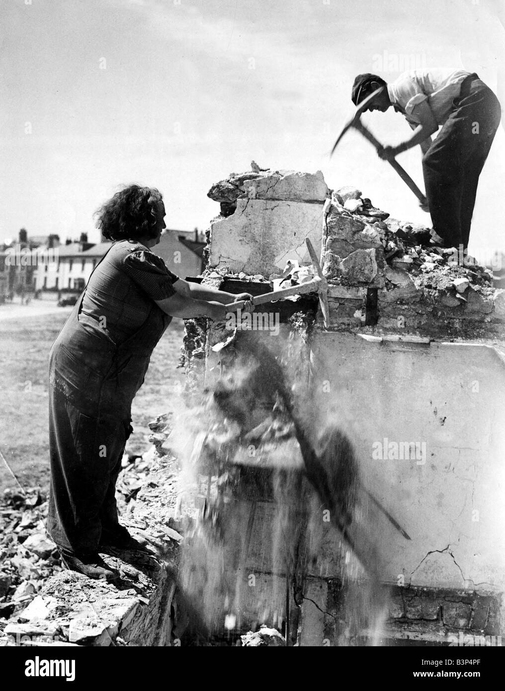 Plymouth s squad of professional women navvies hard at work with the men pulling down bombed premises to make way for rebuilding in the city One of the women is Mrs Vera Bennett left July 1947 Stock Photo