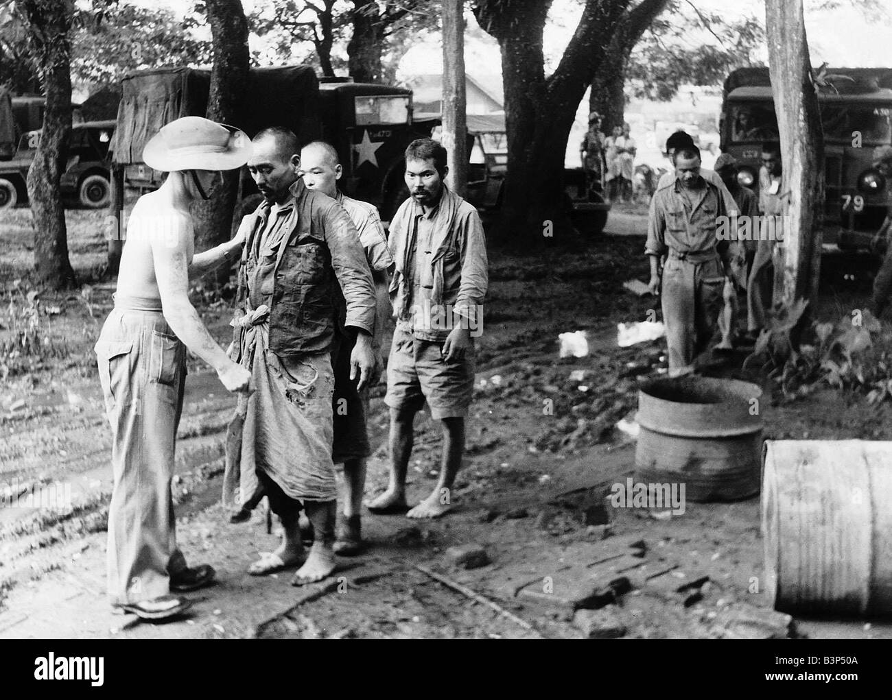 WW2 Japanese prisoners being searched by Lance Corporal Smith after