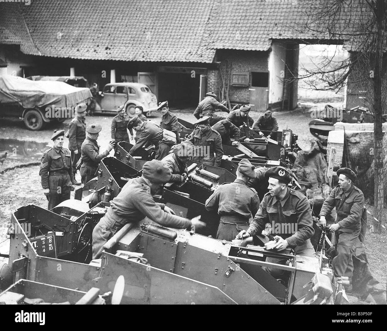 WW2 Gordon Highlanders in France March 1940 cleaning and attending to their Bren carriers in a farmyard Stock Photo
