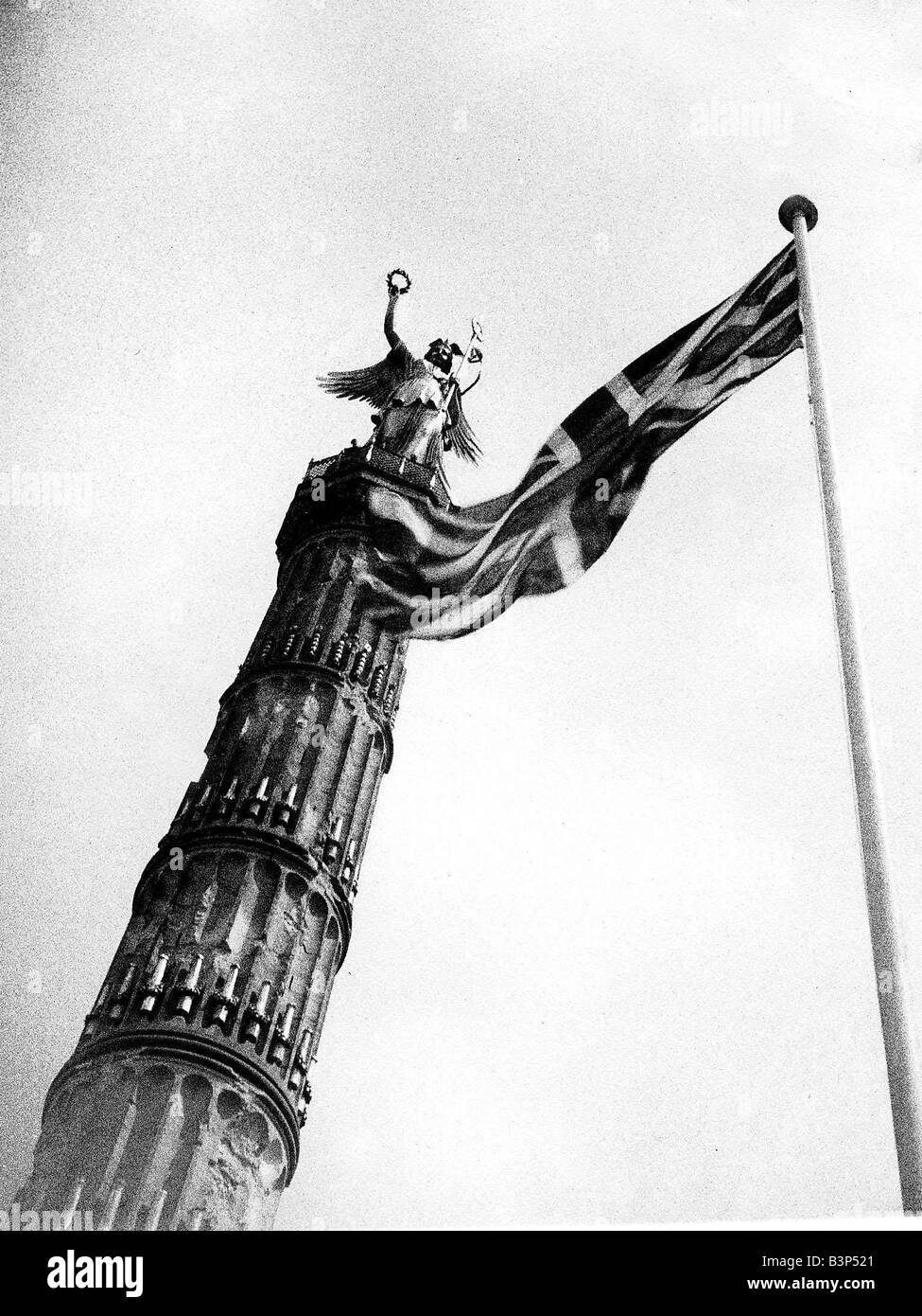 Union Jack flag flying beside the German victory column from the war of 1870 Stock Photo