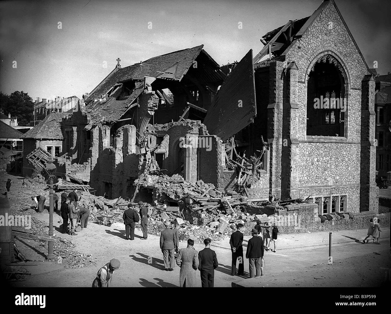 Bomb damaged Plymouth during WW2 People survey the damage left after an air raid bomb Stock Photo