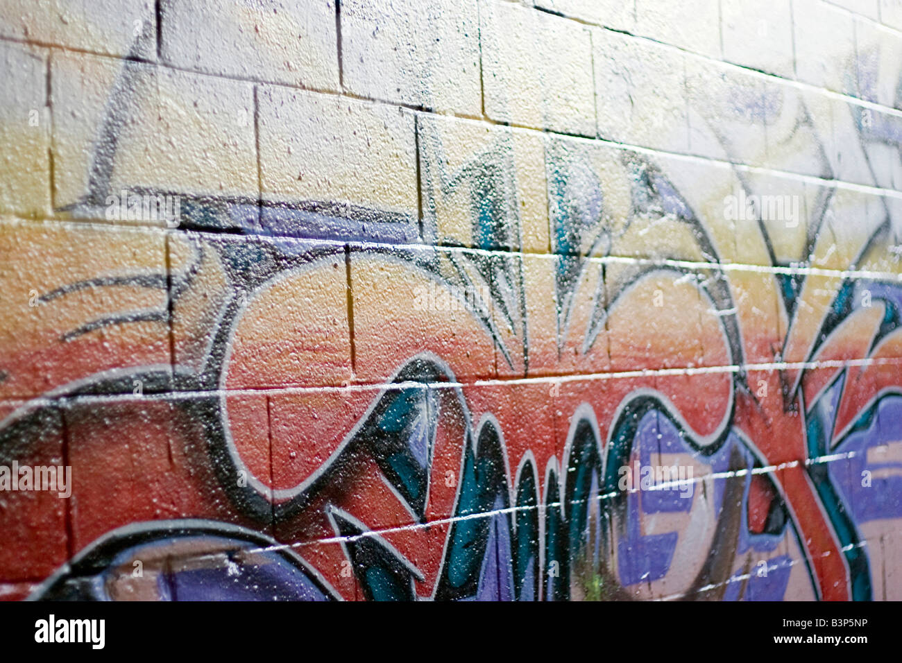 Colorful graffiti spray painted on a brick wall This makes a great background or backdrop Stock Photo