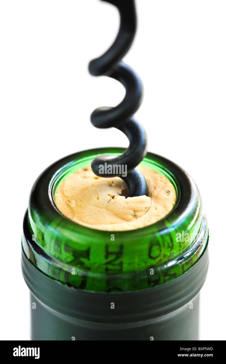 Opening wine bottle with a corkscrew on white background Stock Photo