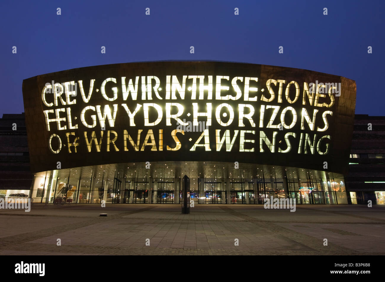 Wales Millennium Centre Cardiff Bay Wales UK at night, exterior, illuminated facade, welsh and english words by Gwyneth Lewis Stock Photo