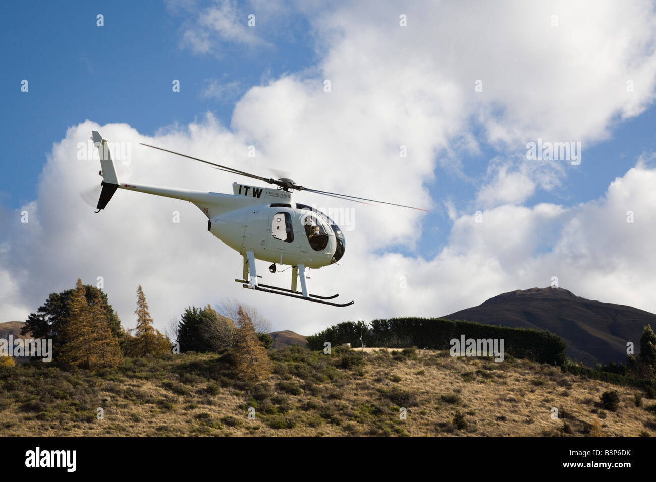 Wanaka Otago South Island New Zealand May Chartered helicopter flying above hill on scenic tour Stock Photo