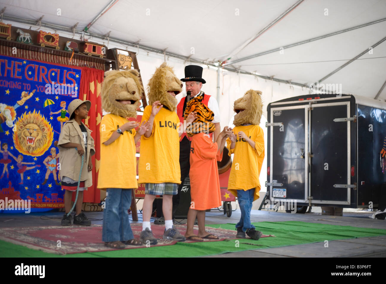 children participating in circus show wearing lion masks at New Mexico state fair Stock Photo