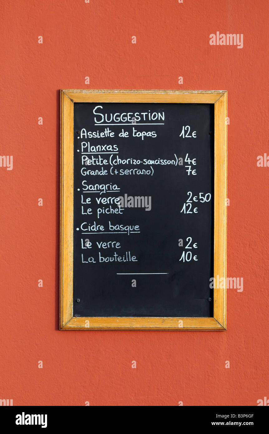 A menu in French language advertising local food outside a restaurant in St Jean de Luz, France. Stock Photo