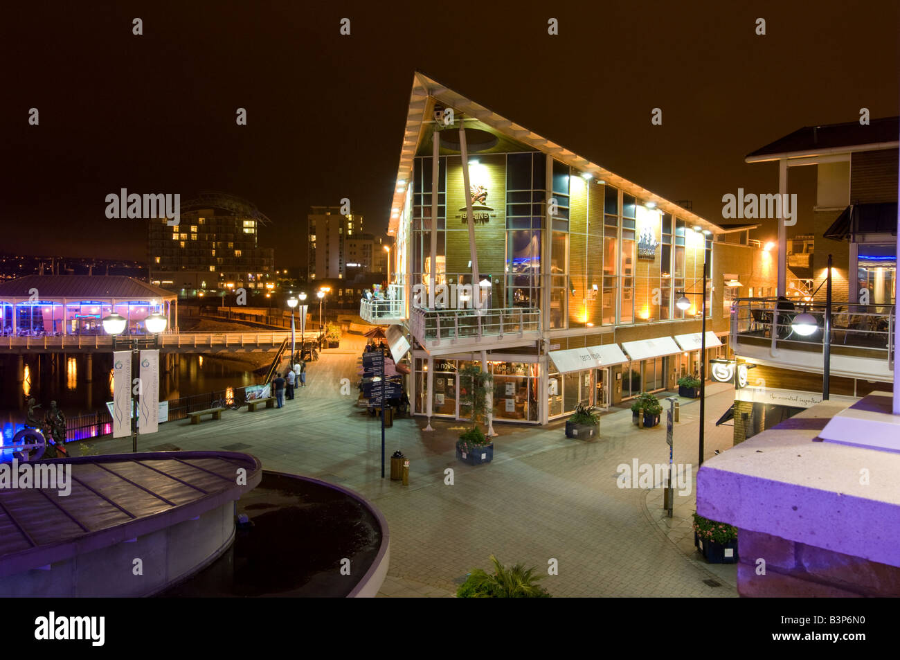 pubs bars and restaurant on Mermaid Quay Cardiff bay at night Wales UK Stock Photo