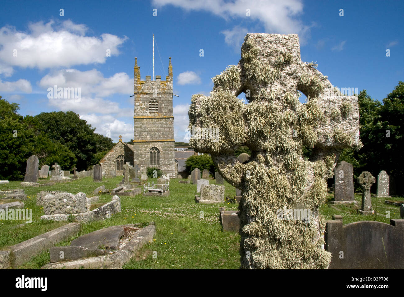 Church tower, spire, steeple of Perranuthnoe Church, St. Piran & St. Michael, Cornwall, England, graveyard, gravestones. Stock Photo