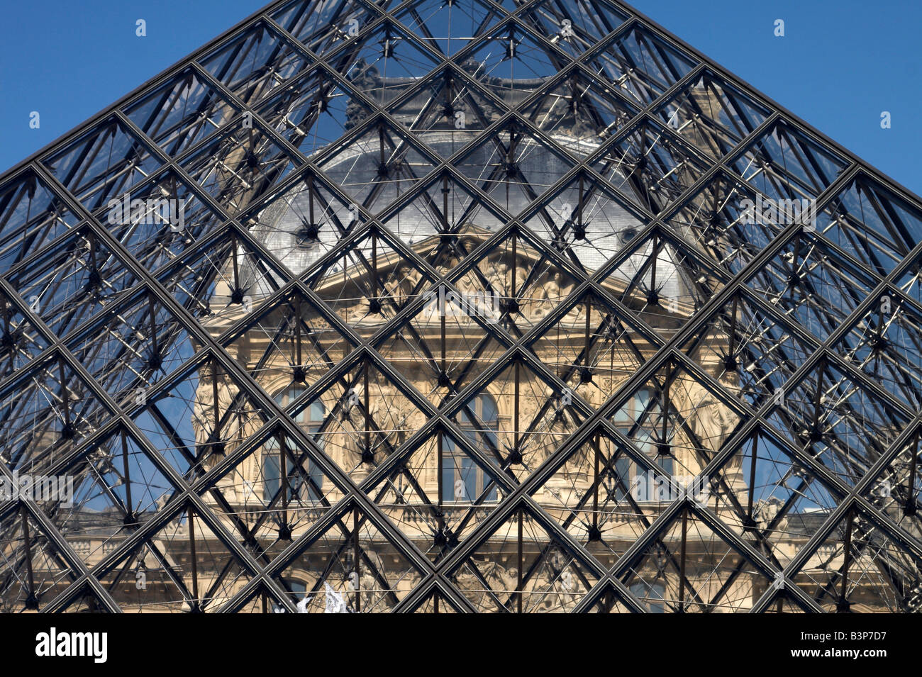 The Louvre museum and glass pyramid in Paris, France Stock Photo