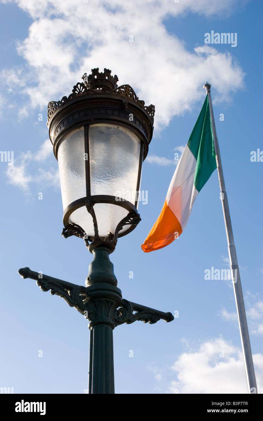 Decorative traditional street lamp and Irish flag flapping in the wind