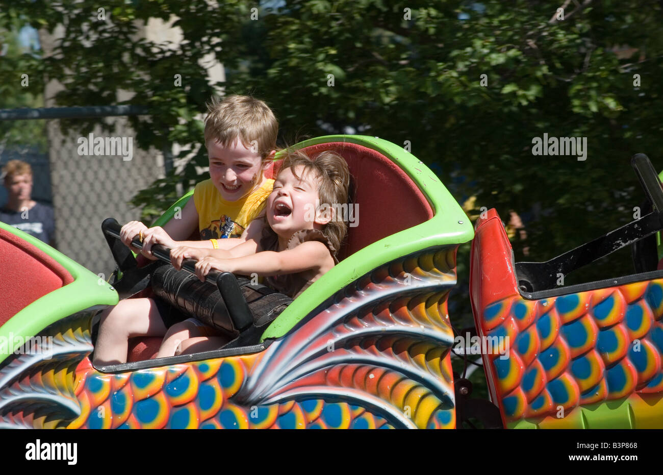 2 children having fun on a roller coaster. Stock Photo