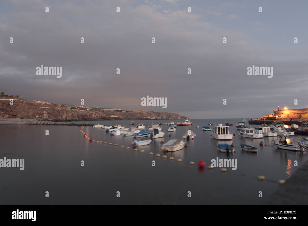 Harbour and boats at dusk with a long exposure in Playa San Juan Tenerife Canary Islands Spain Stock Photo