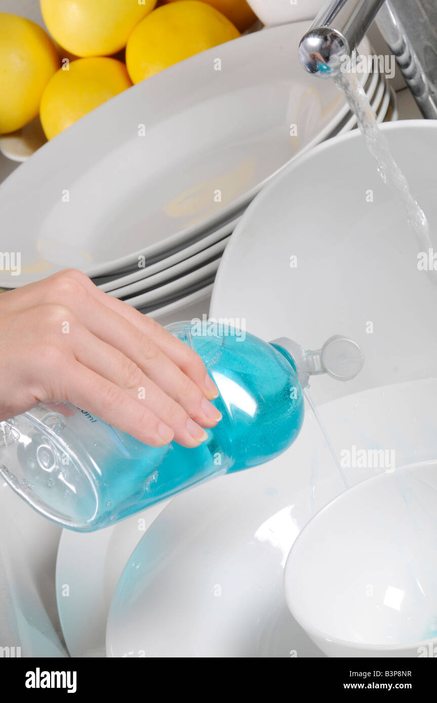WASHING UP WITH LIQUID DISH SOAP Stock Photo