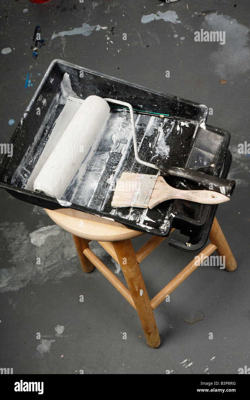 Paint pan and paint roller on stool with paint brush Stock Photo Alamy